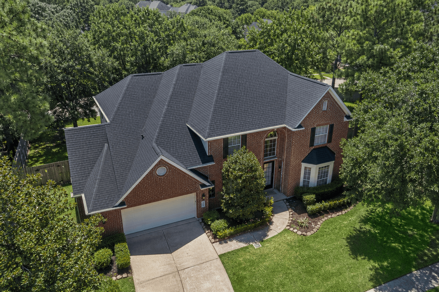 The same Houston home with a brand-new architectural shingle roof installed by Texas Premier Contractors